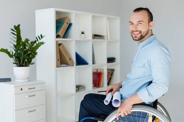 businessman in wheelchair holding documents