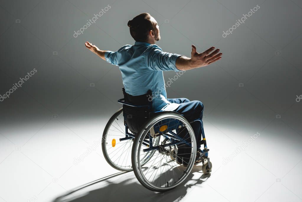 Disabled man posing with arms outstreched