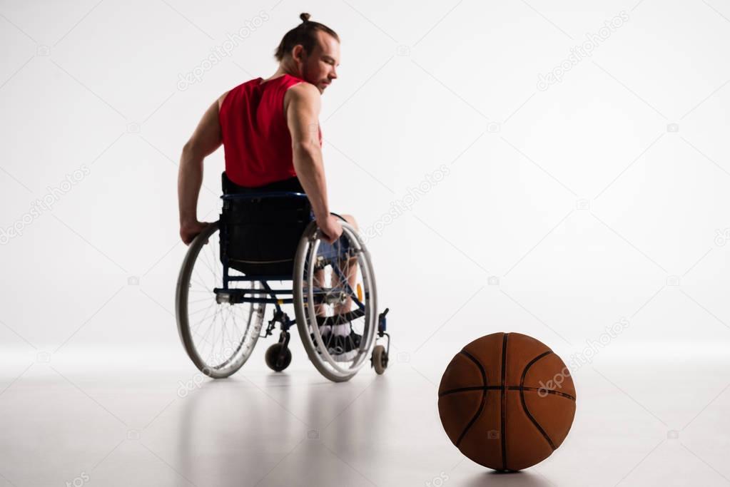 paralympic in wheelchair with basketball ball