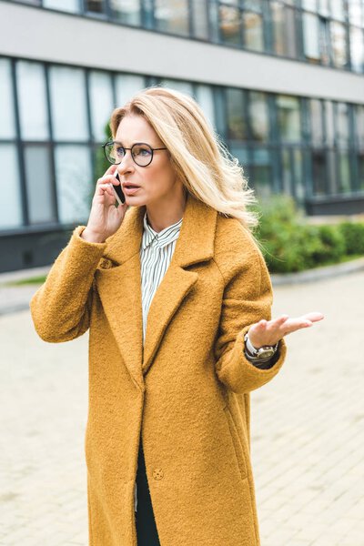 confused woman talking on smartphone