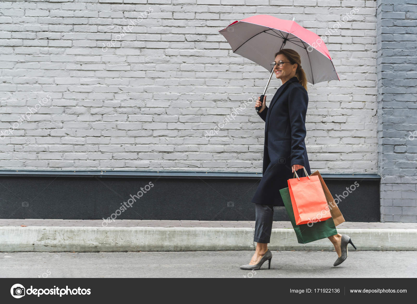 Woman with umbrella and shopping bags — Stock Photo © NatashaFedorova ...
