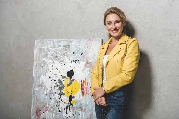 Blonde woman with painting — Stock Photo, Image