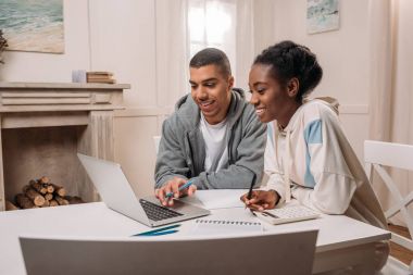 african american couple using laptop clipart