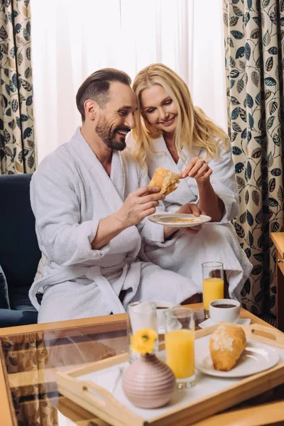 Happy Mature Couple Eating Pastry Breakfast Together Hotel Room — Free Stock Photo