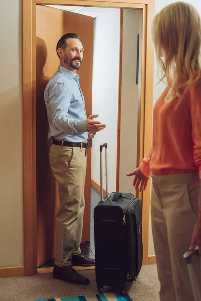 Mature Couple Suitcases Entering Hotel Room — Free Stock Photo