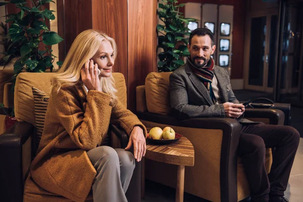 Middle Aged Couple Using Smartphones While Sitting Waiting Hotel Hallway — Free Stock Photo