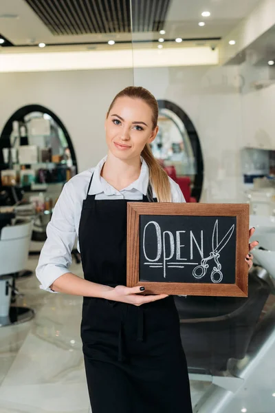Smiling Blonde Hairdresser Showing Sign Open — Stock Photo, Image
