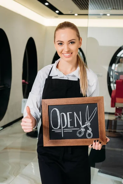 Smiling Hairdresser Holding Signboard Open Showing Thumb — Stock Photo, Image