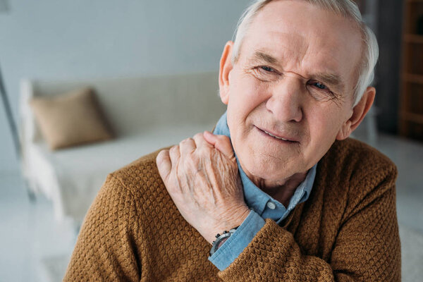 Senior man suffering from back pain