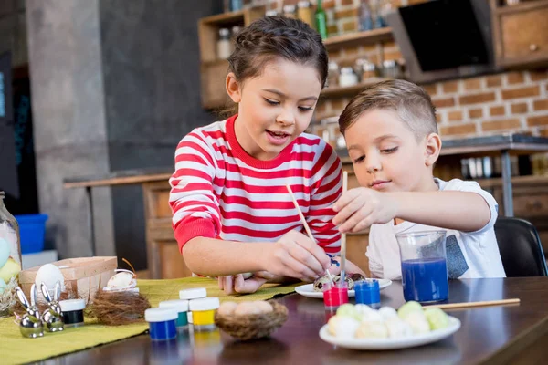 Kids painting easter eggs — Stock Photo