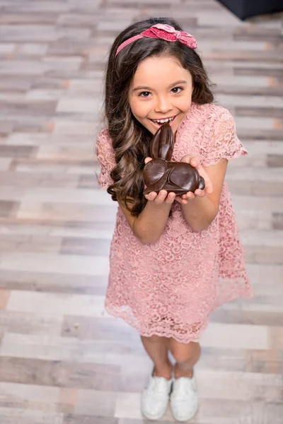 Little girl with chocolate bunny — Stock Photo