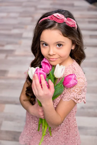 Little girl with flowers — Stock Photo