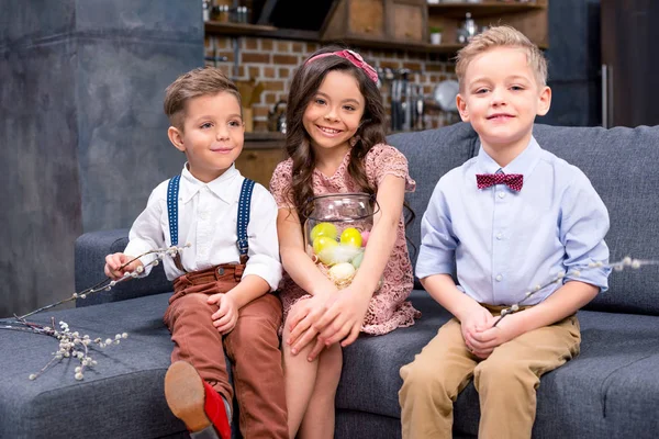 Kids with Easter eggs and catkins — Stock Photo