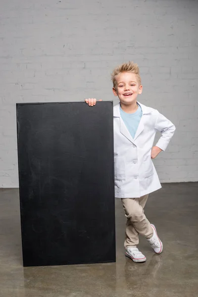 Boy holding blackboard — Stock Photo