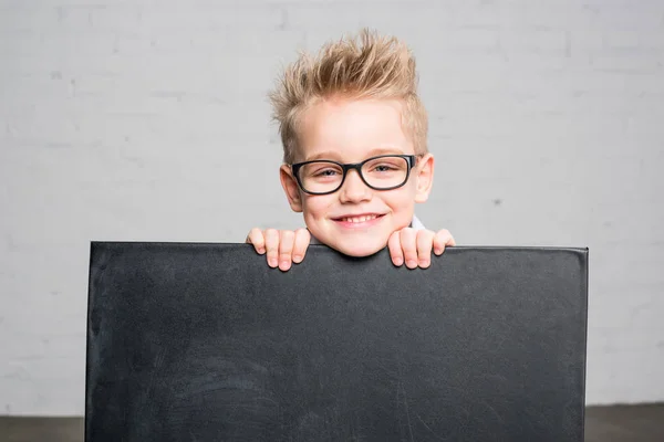 Boy holding blackboard — Stock Photo