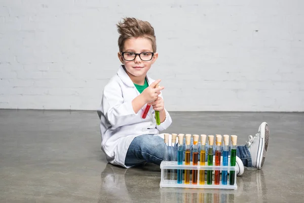 Little boy with test tubes — Stock Photo