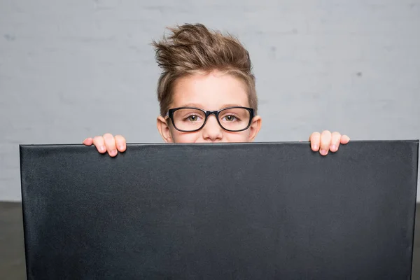 Boy holding blackboard — Stock Photo