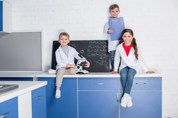 Niños en laboratorio químico - foto de stock