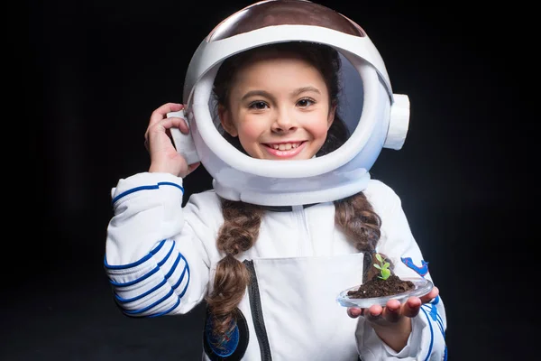 Menina astronauta segurando planta — Fotografia de Stock