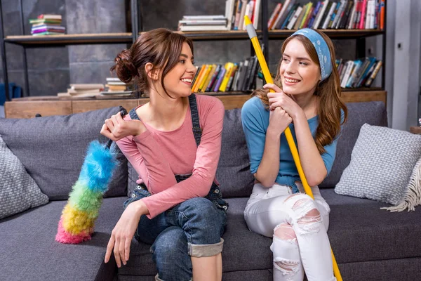 Young women with cleaning tools — Stock Photo