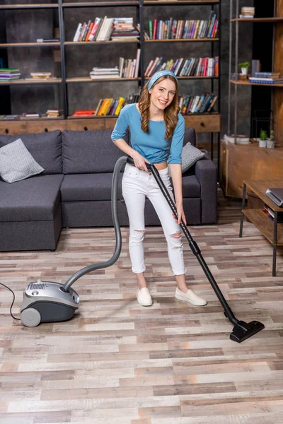 Woman with vacuum cleaner — Stock Photo