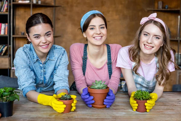 Frauen mit Pflanzen in Blumentöpfen — Stockfoto