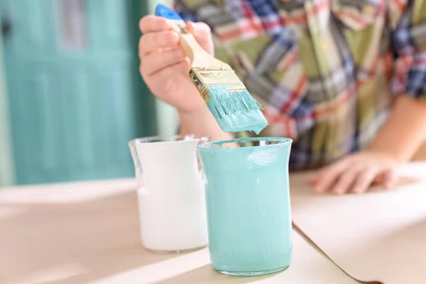 Boy with paintbrush and paints — Stock Photo