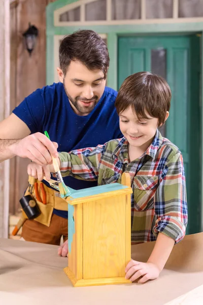 Батько і син роблять пташиний будинок — стокове фото