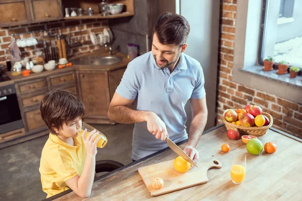 Father and son drinking juice — Stock Photo