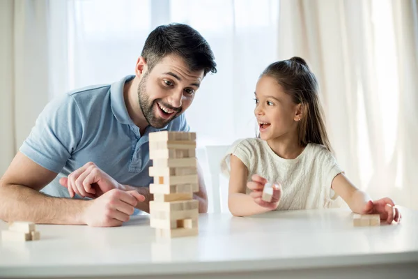 Family playing jenga game — Stock Photo