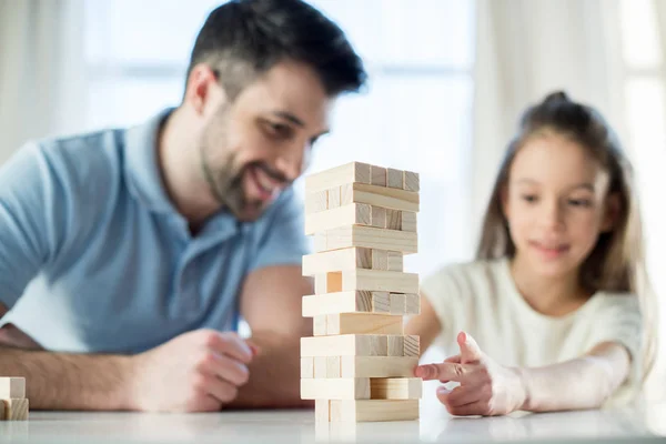 Family playing jenga game — Stock Photo