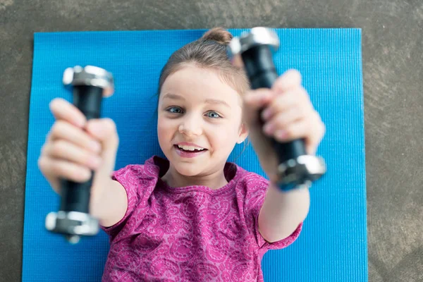 Girl exercising with dumbbells — Stock Photo