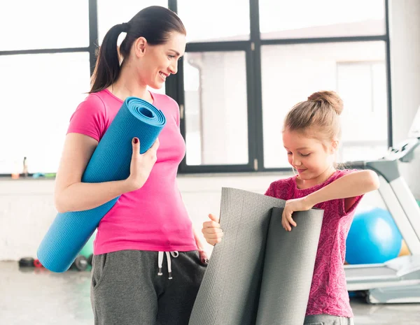 Mother and daughter with yoga mats — Stock Photo