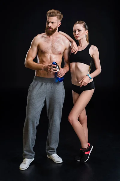 Sportsman with sport bottle and sportswoman — Stock Photo