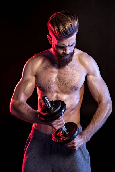 Bodybuilder training with dumbbell — Stock Photo