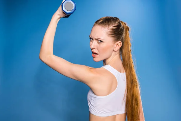 Sportswoman training with dumbbell — Stock Photo