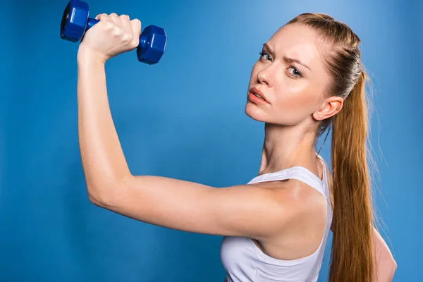 Sportswoman training with dumbbell — Stock Photo