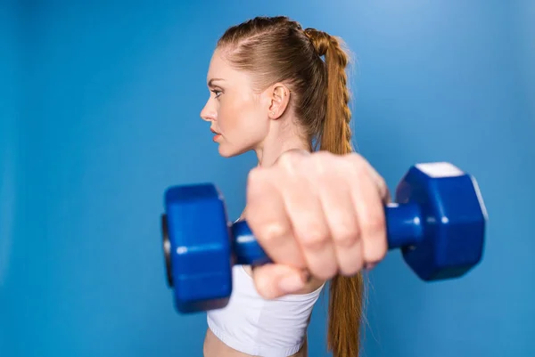 Sportswoman training with dumbbell — Stock Photo