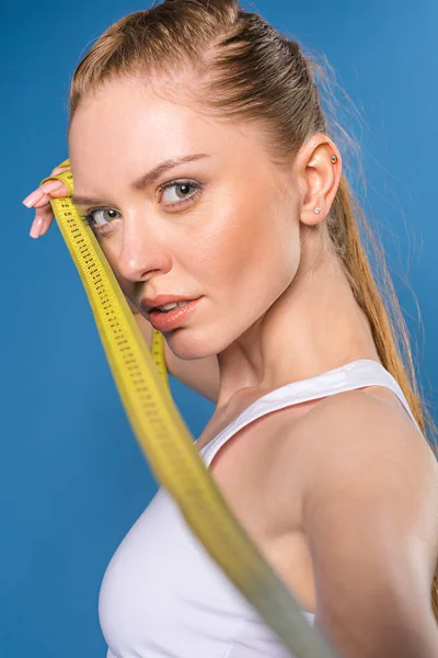 Sportswoman with measuring tape — Stock Photo