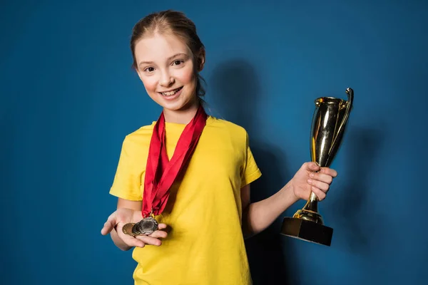 Girl with medals and trophy — Stock Photo