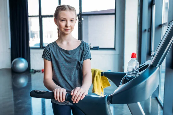 Preteen girl training on treadmill — Stock Photo