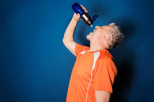 Mature sportsman with bottle — Stock Photo