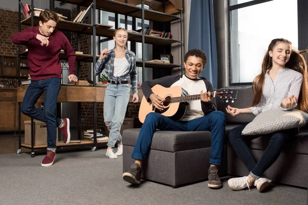 Adolescentes tocando guitarra acustica - foto de stock