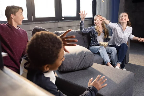 Teenagers having fun with popcorn — Stock Photo