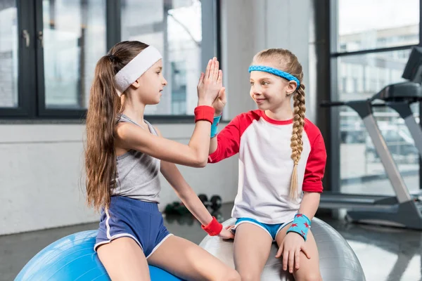 Little girls in sportswear at fitness studio — Stock Photo