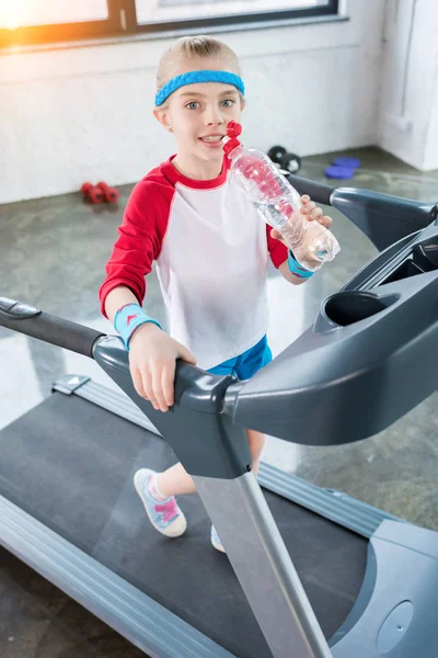 Kid girl training on treadmill — Stock Photo