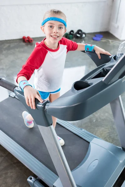 Kid girl training on treadmill — Stock Photo