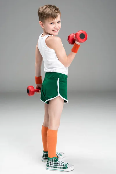 Active boy with dumbbells — Stock Photo