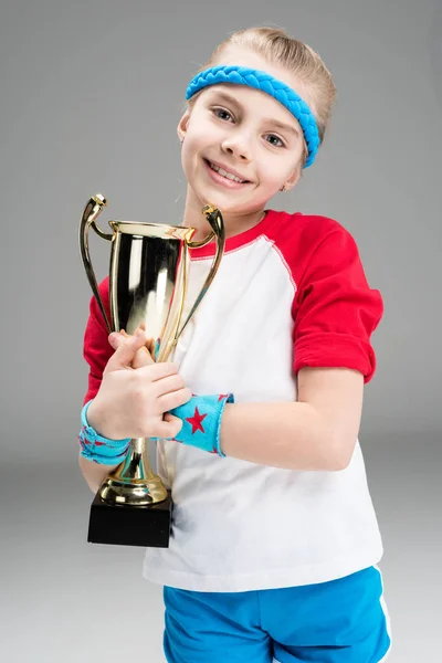 Active girl with champion's goblet — Stock Photo