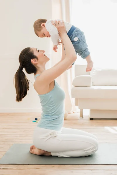Young mother playing with her son — Stock Photo